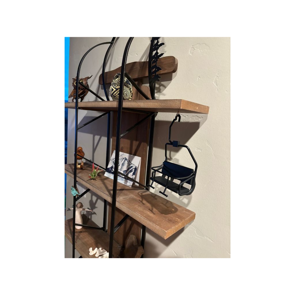 small decorative ski chair hanging from shelf