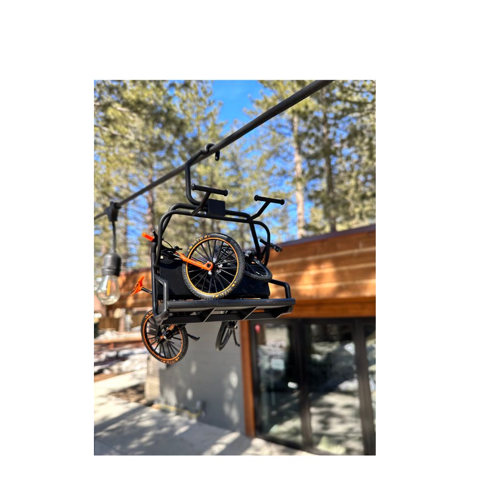 miniature mountain bikes hanging on mini ski chair